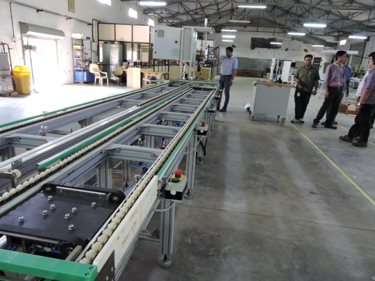 Penta Automation team reviewing a completed conveyor line at the facility